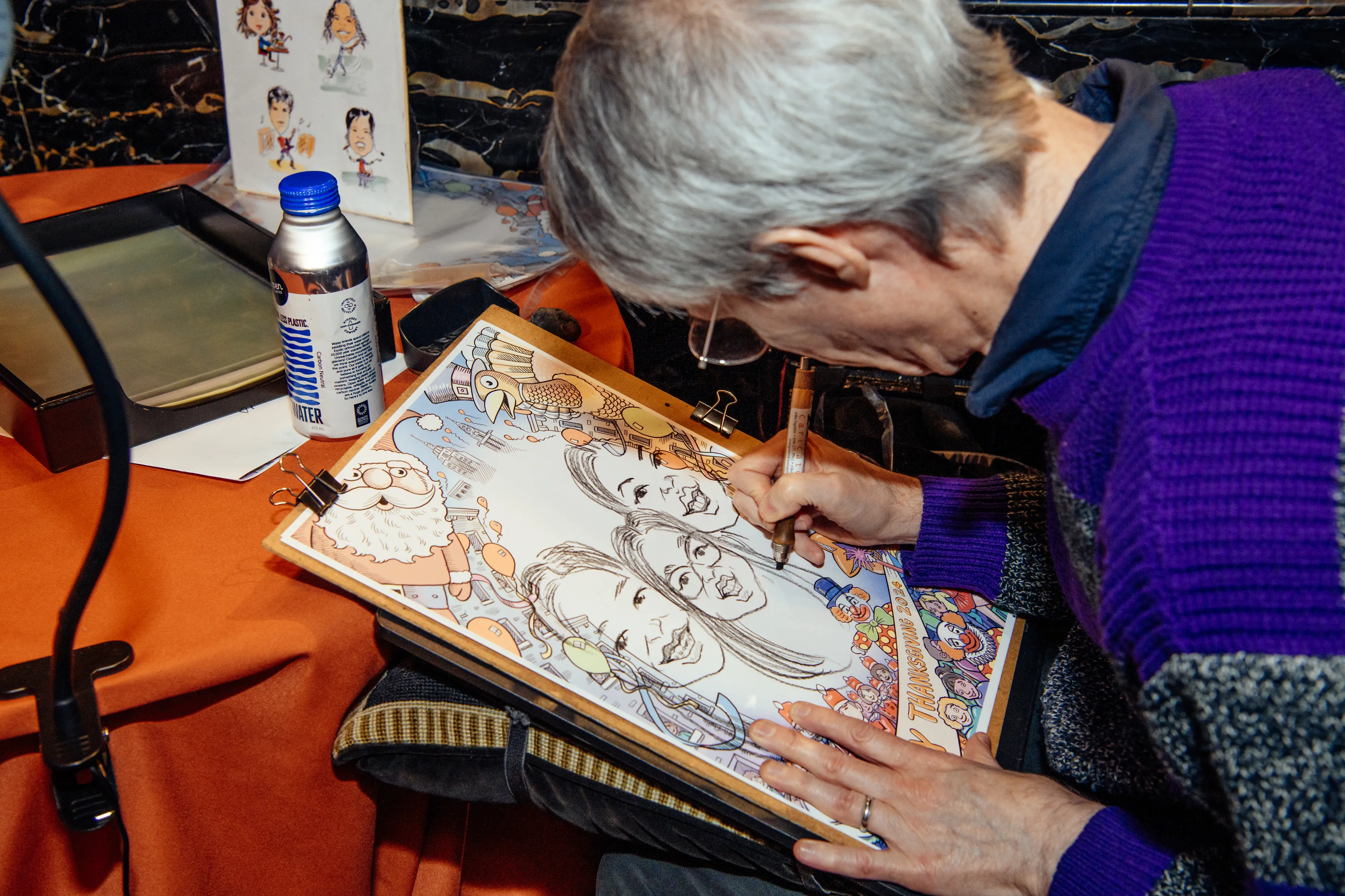 A caricature artist sketching guests at the Gotham Hall Thanksgiving parade brunch