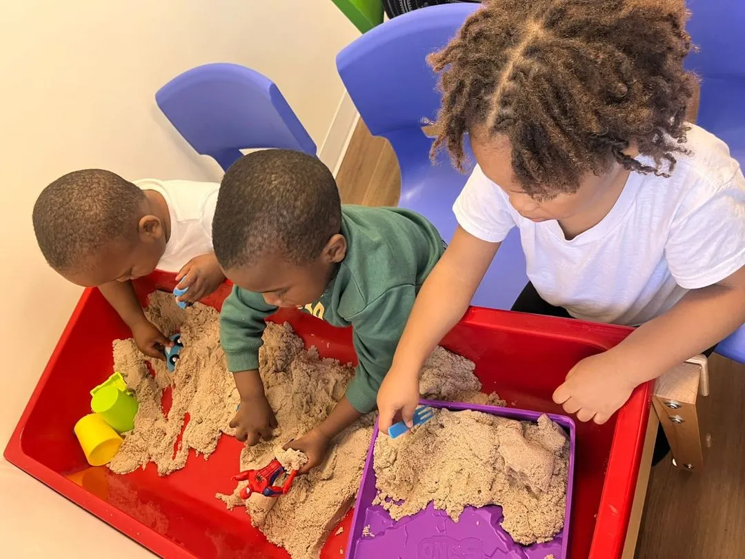 Kids exploring a sensory bin at a Ruby ABA clinic