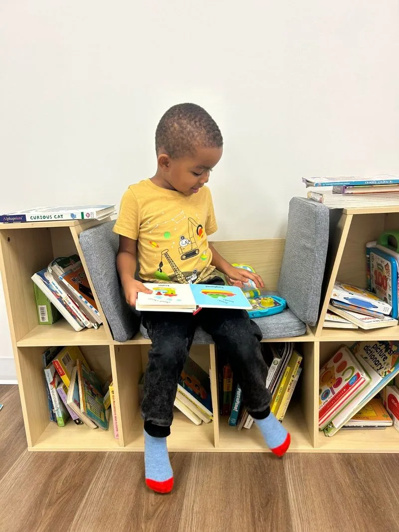 A child reading in the clinic book nook