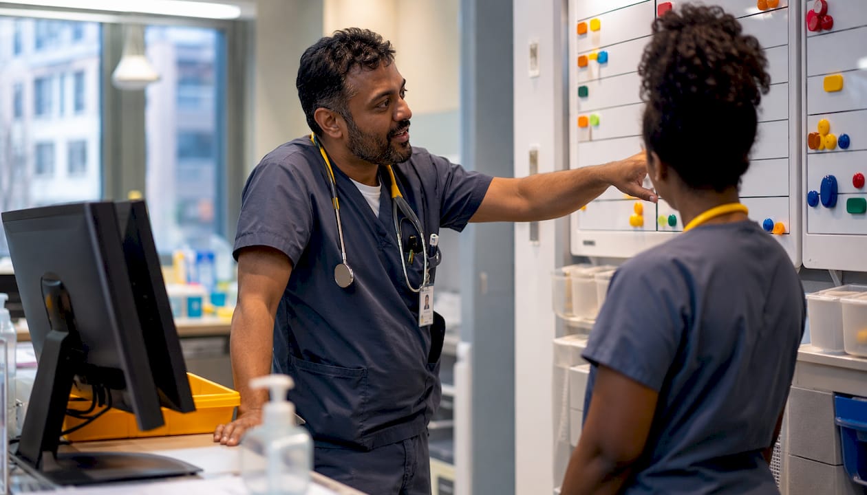 Nurses collaborating at hospital workstation