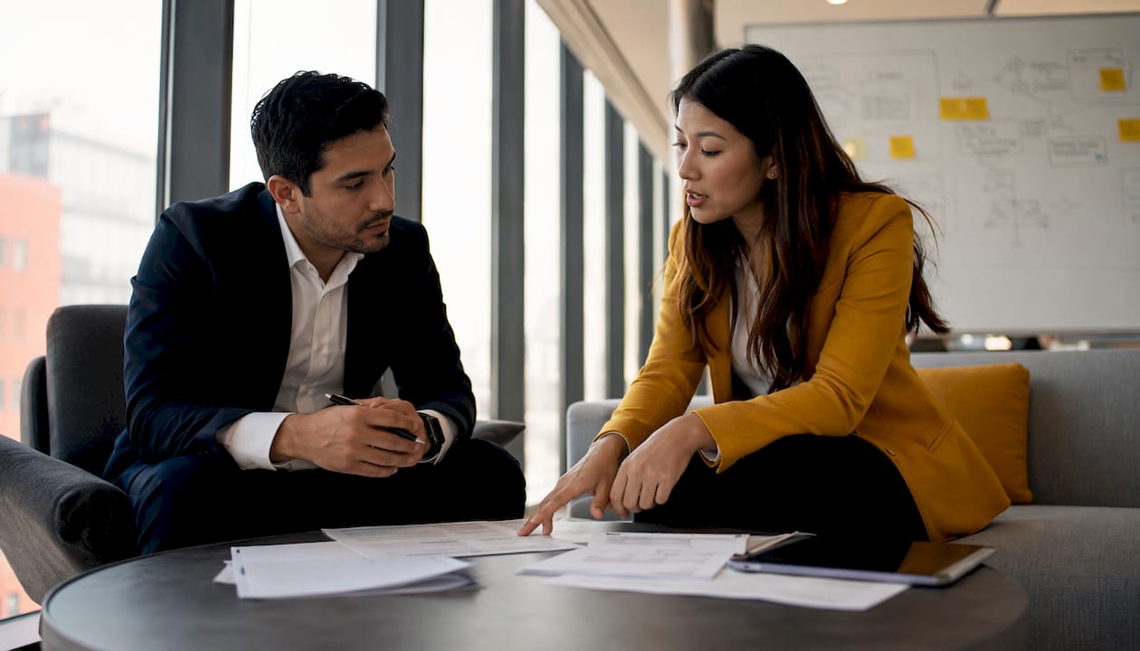 Two professionals discussing legal outsourcing contracts