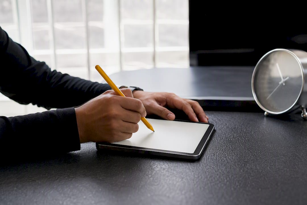Hands checking data on blank tablet in contact center