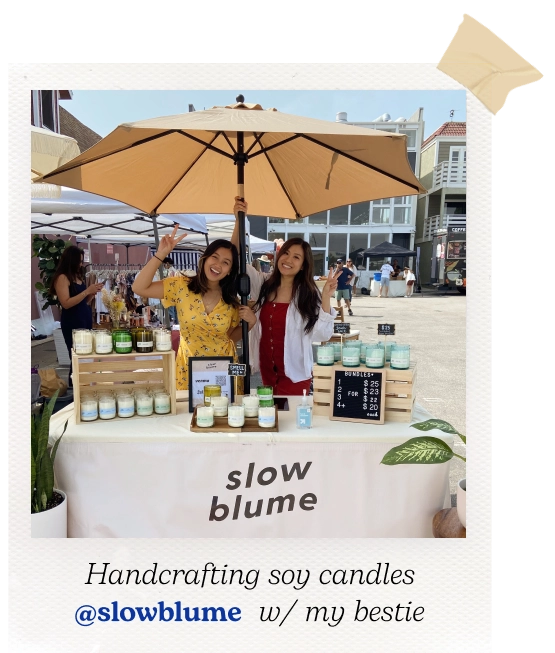 Polaroid picture of Stephanie and her business partner at a pop-up shop for their brand Slow Blume. Caption reads "Handcrafting soy candles @Slowblume with my bestie".