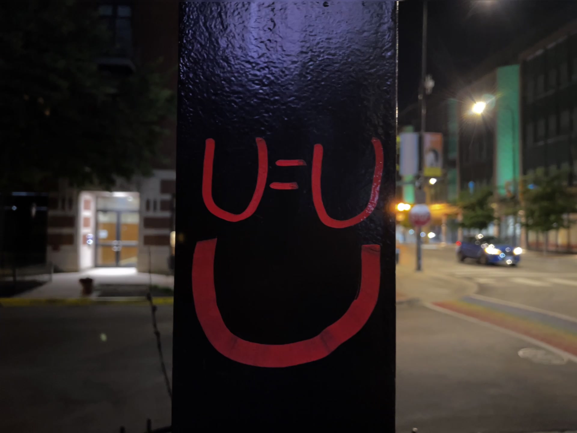 Red U=U smiley tag on black