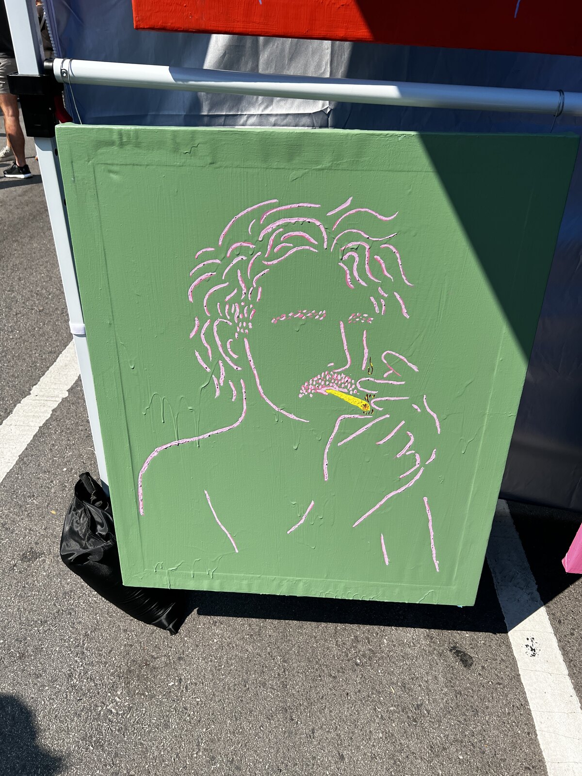 Green filament painting hung at the Q.M.M. Market Days booth