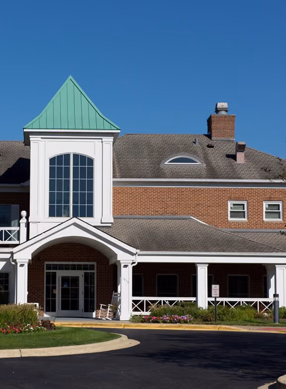 River Glen of St. Charles seniors housing community, a brick building with a green-roofed cupola and white columned entrance