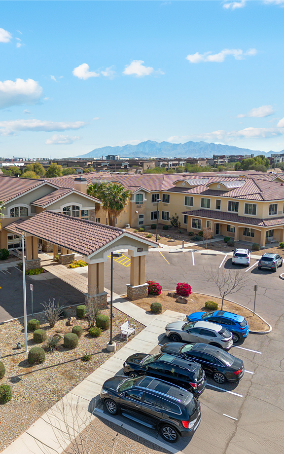 Aerial view of a Project Oaks & Groves seniors housing community in Arizona, with tile roofs and mountains beyond