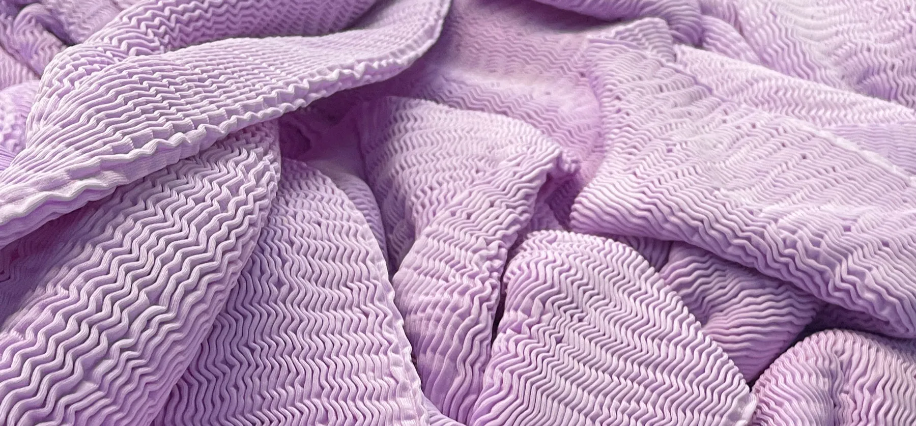 Lilac coloured Cienna fabric folded over itself
