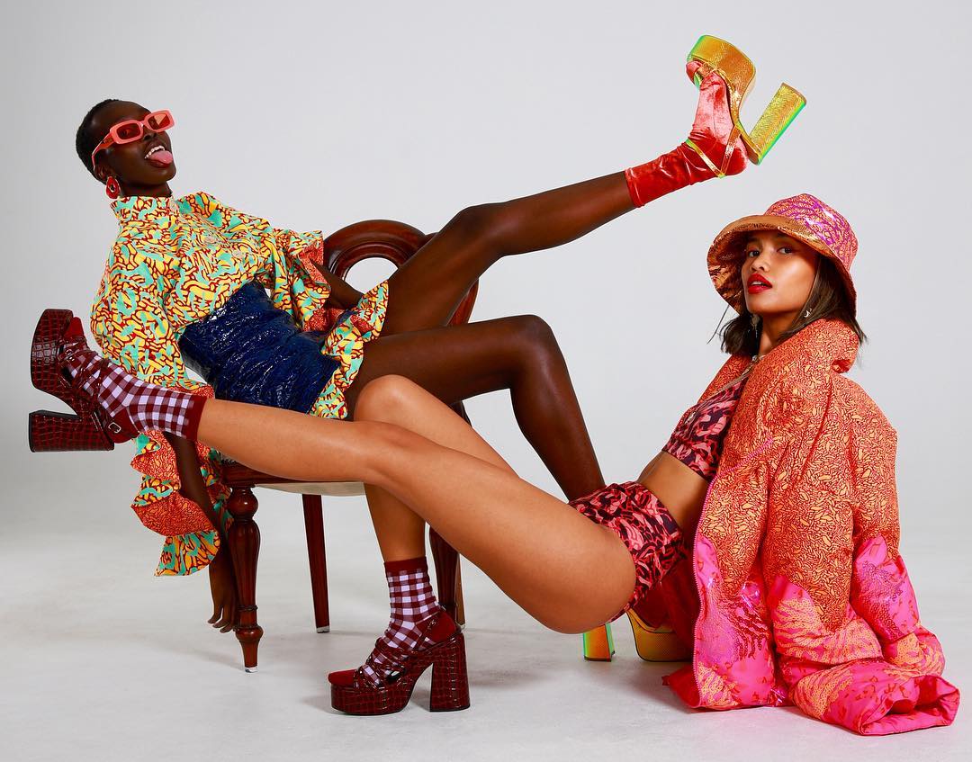 Two women wearing custom printed outfits for Meeki World