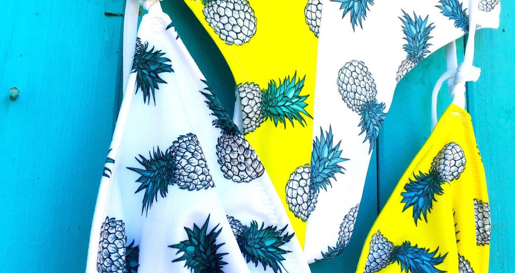 Custom printed two piece swimsuit featuring white and yellow stripes and pineapples all over
