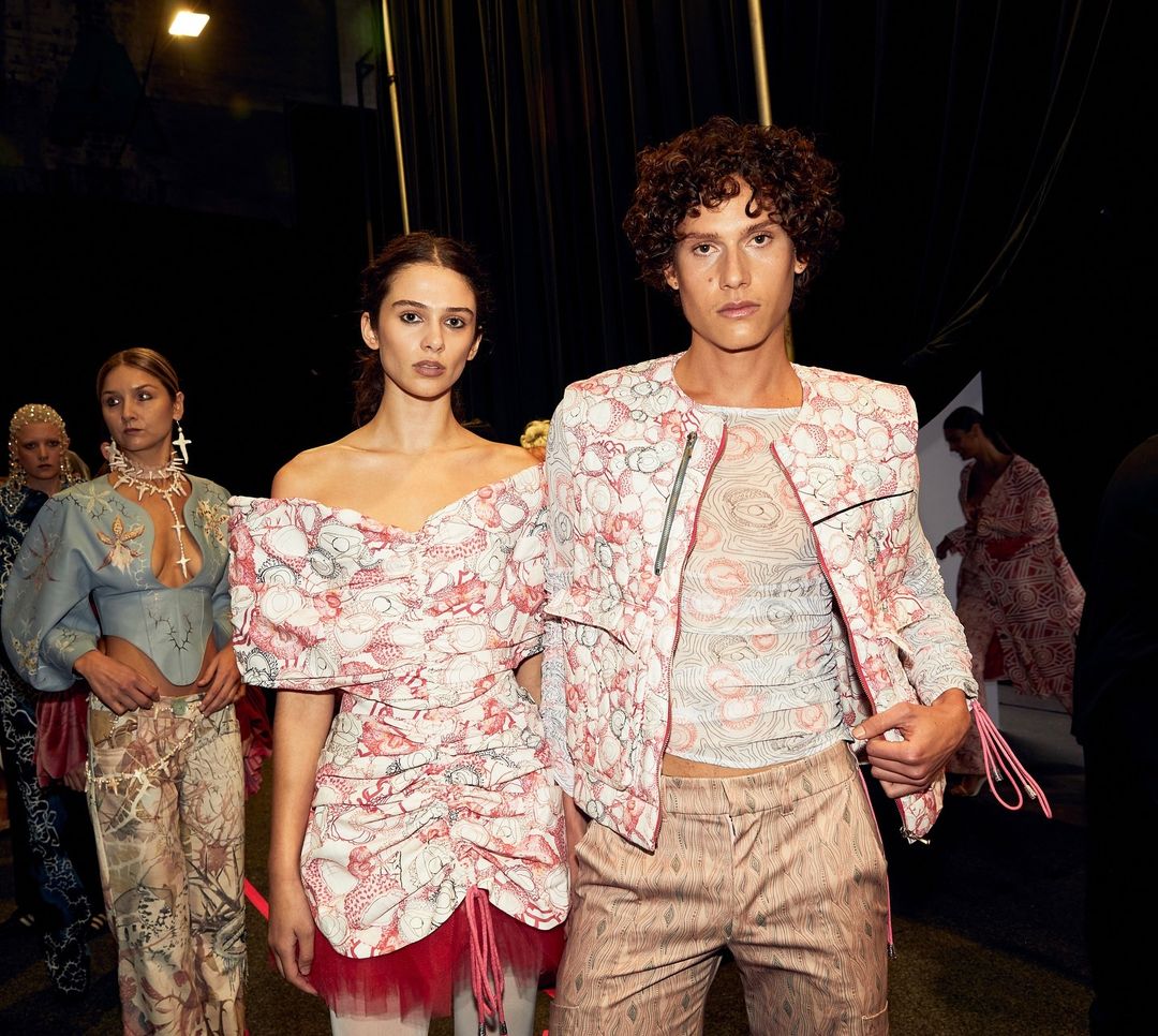 Male and female models wearing  custom printed white and red outfits