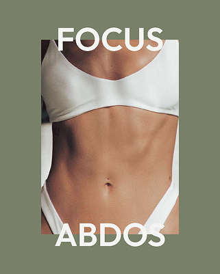 Close-up of a toned midsection wearing a white sports bra and white workout bottoms with the text 'FOCUS ABDOS'.