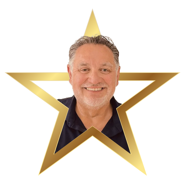 Smiling middle-aged man with gray hair and beard inside a golden star frame.
