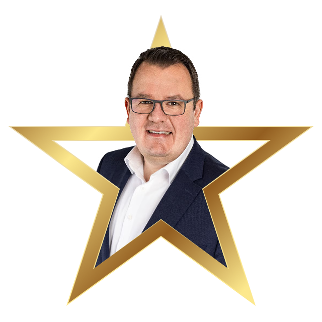 Smiling man wearing glasses, a white shirt, and a dark blazer framed within a gold star outline.