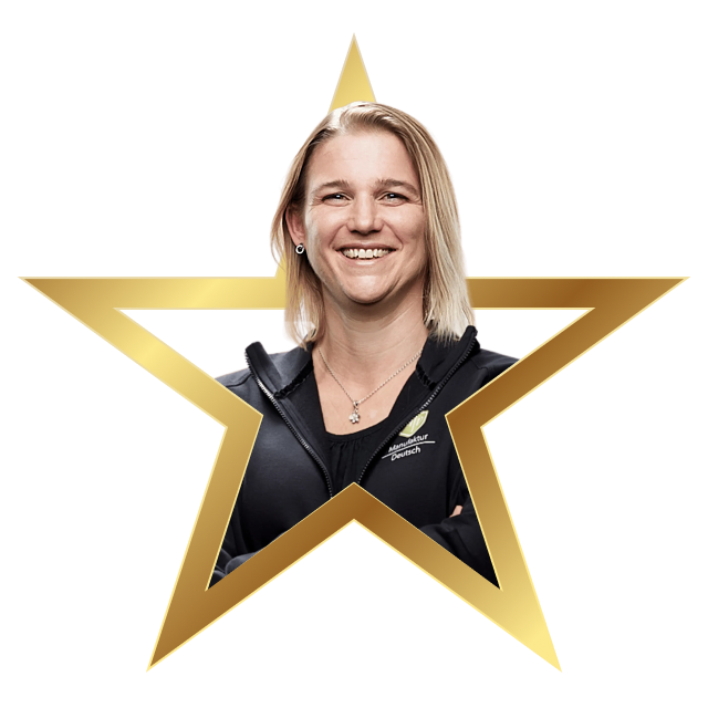 Smiling woman with blonde hair wearing a black jacket framed by a gold star outline.