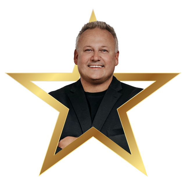 Smiling man in a black blazer and t-shirt framed inside a gold star outline.