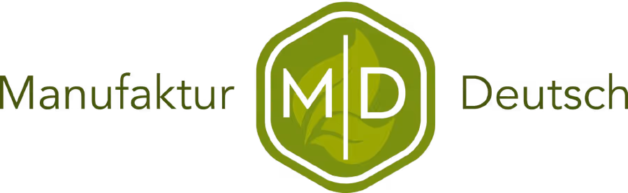 Markus Mensch logo with stylized gold text and an emblem featuring the letter M.