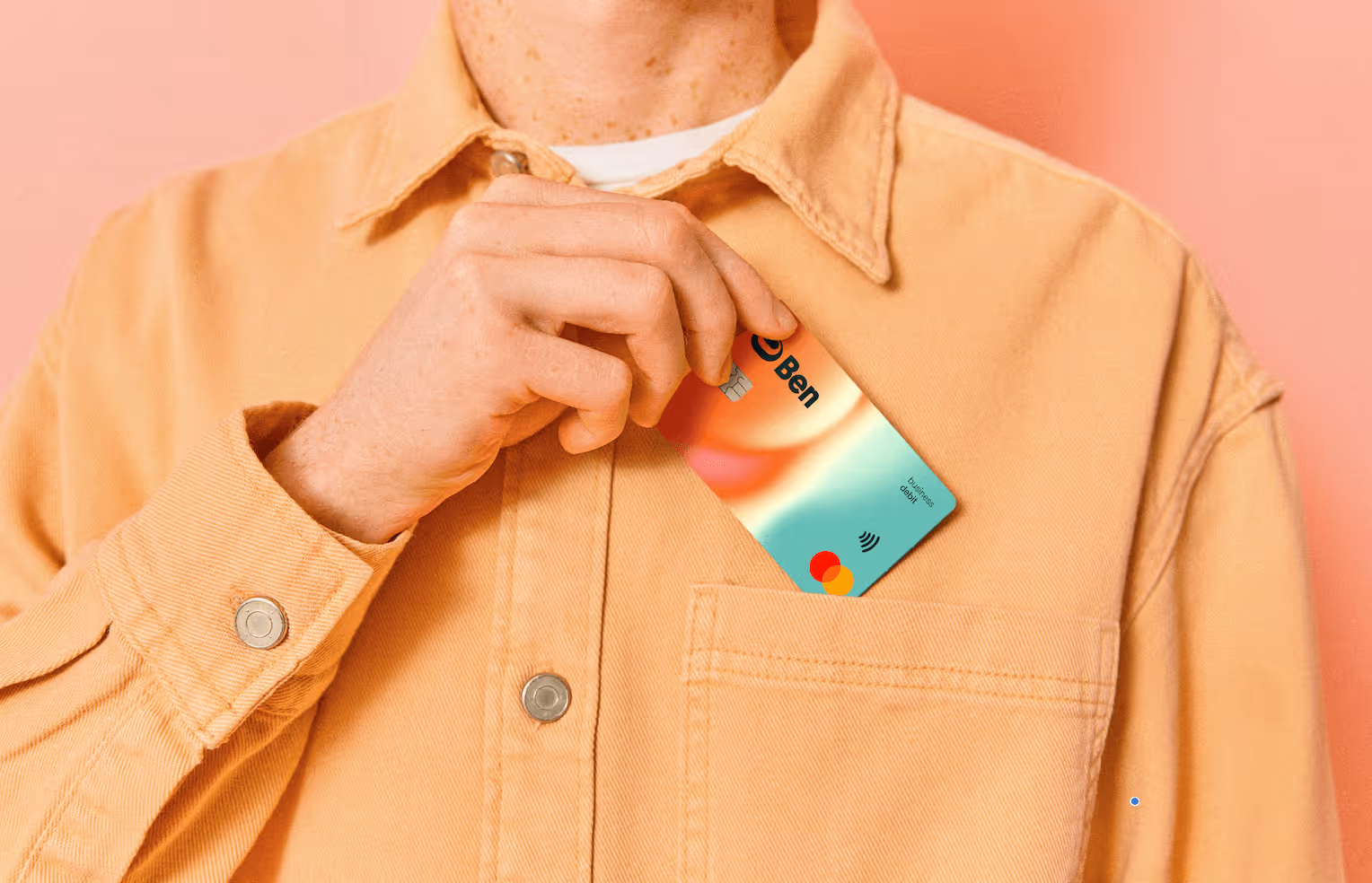 A photo of a person taking a Ben physical payment card out of their shirt pocket