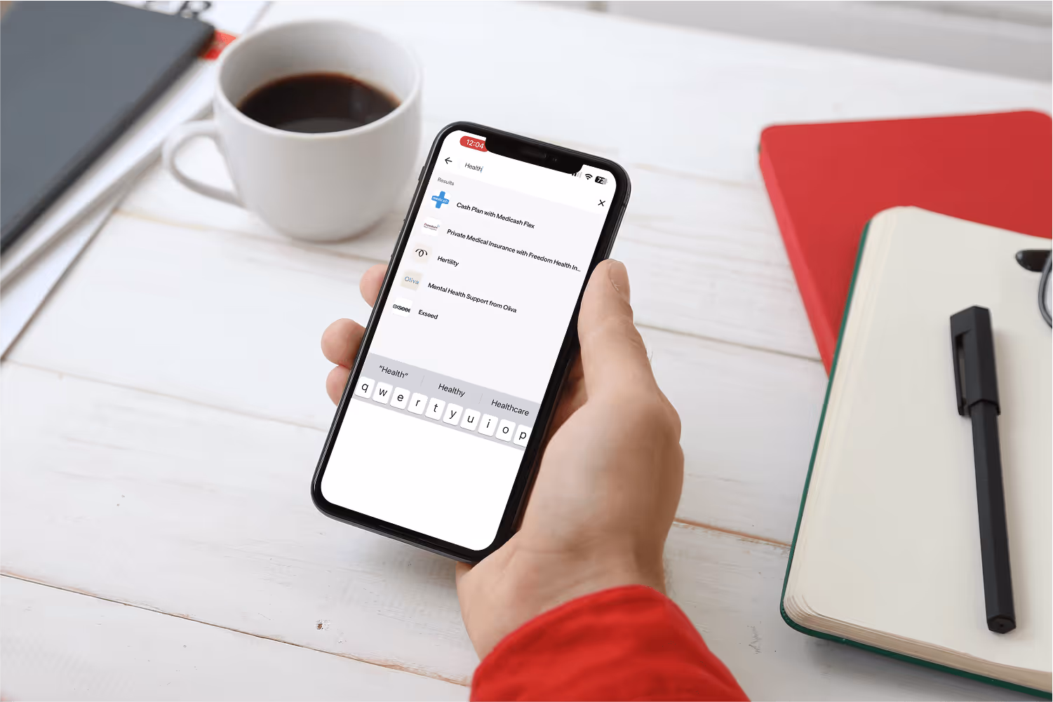 A photo of a hand holding a mobile phone, showing Ben's keyword search functionality