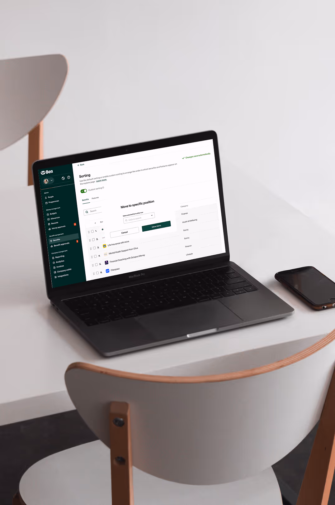 A photo of a laptop featuring Ben's benefit category ranking UI