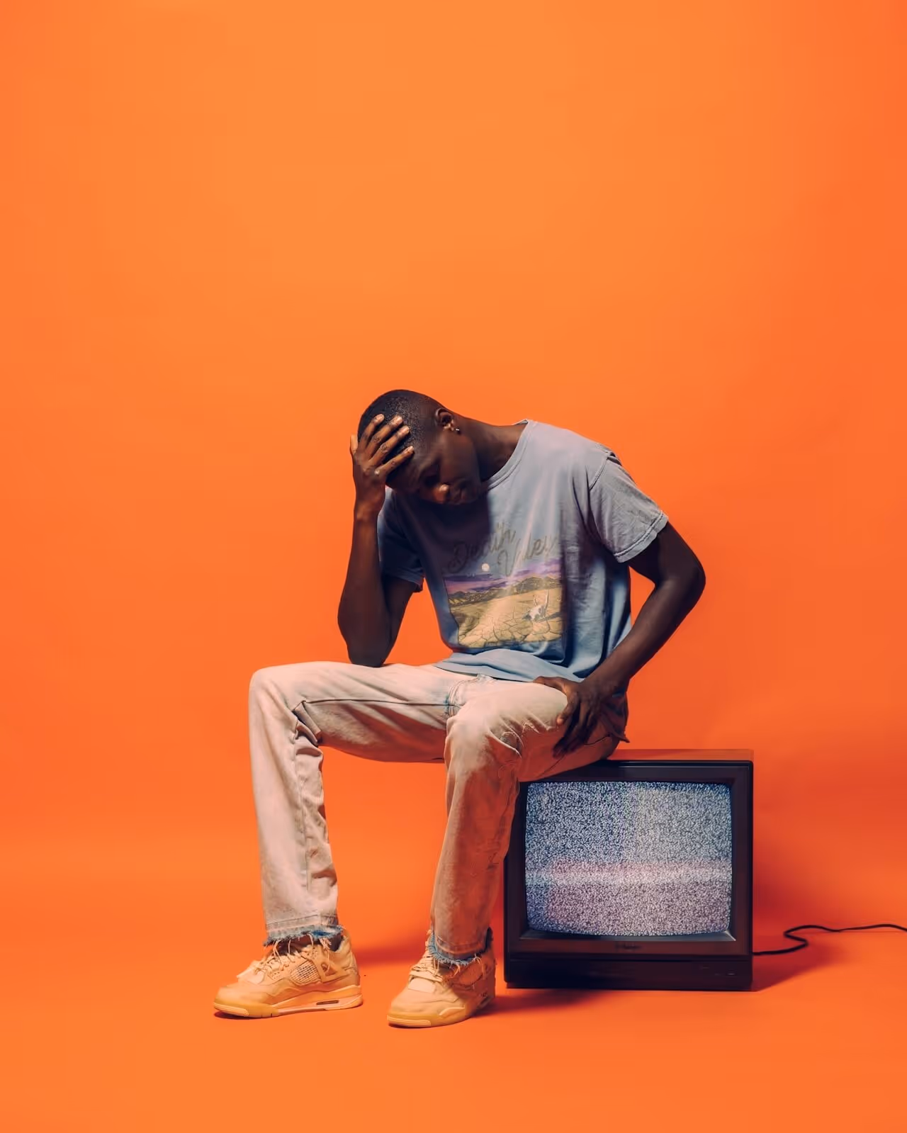 image of a man sat on a tv