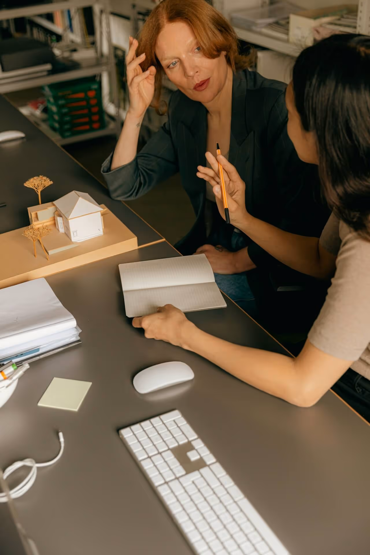 Two colleagues in discussion at a desk — reflecting the cross-functional conversations that follow when benefits data discrep