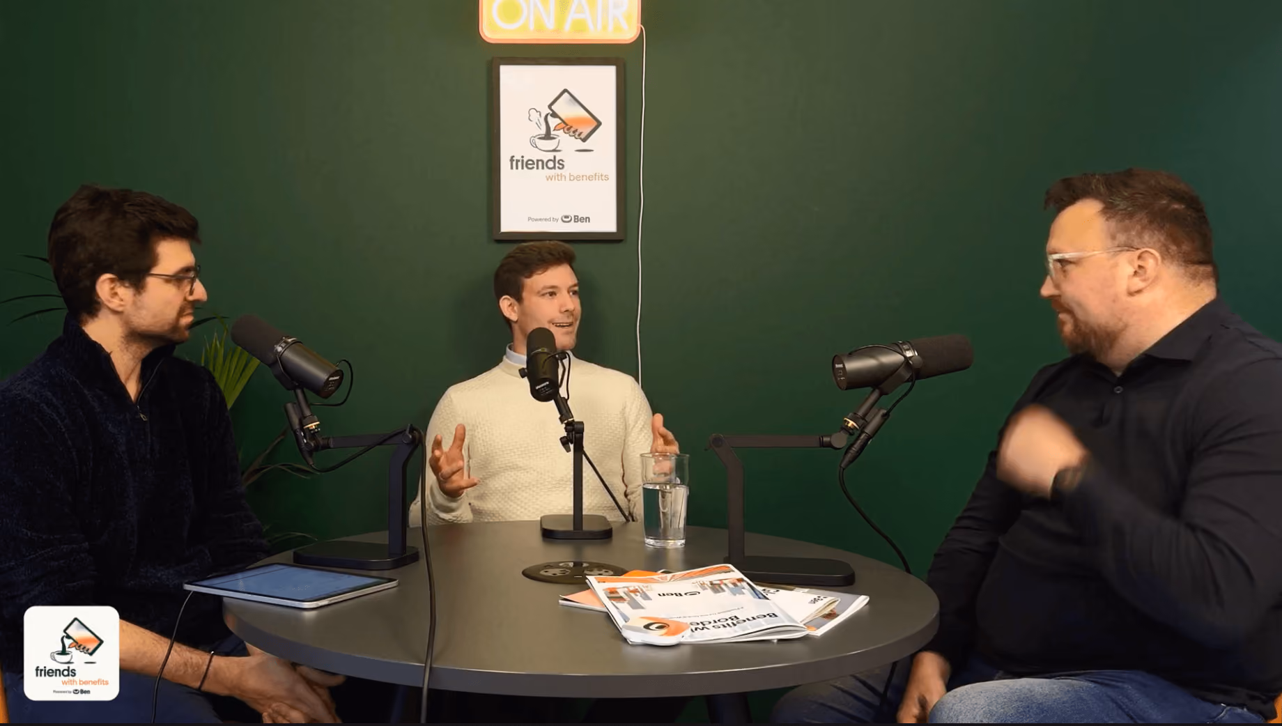 Dino Bertolis, Carl Chapman and David Duckworth in conversation on the Friends with Benefits podcast set, seated at a round t