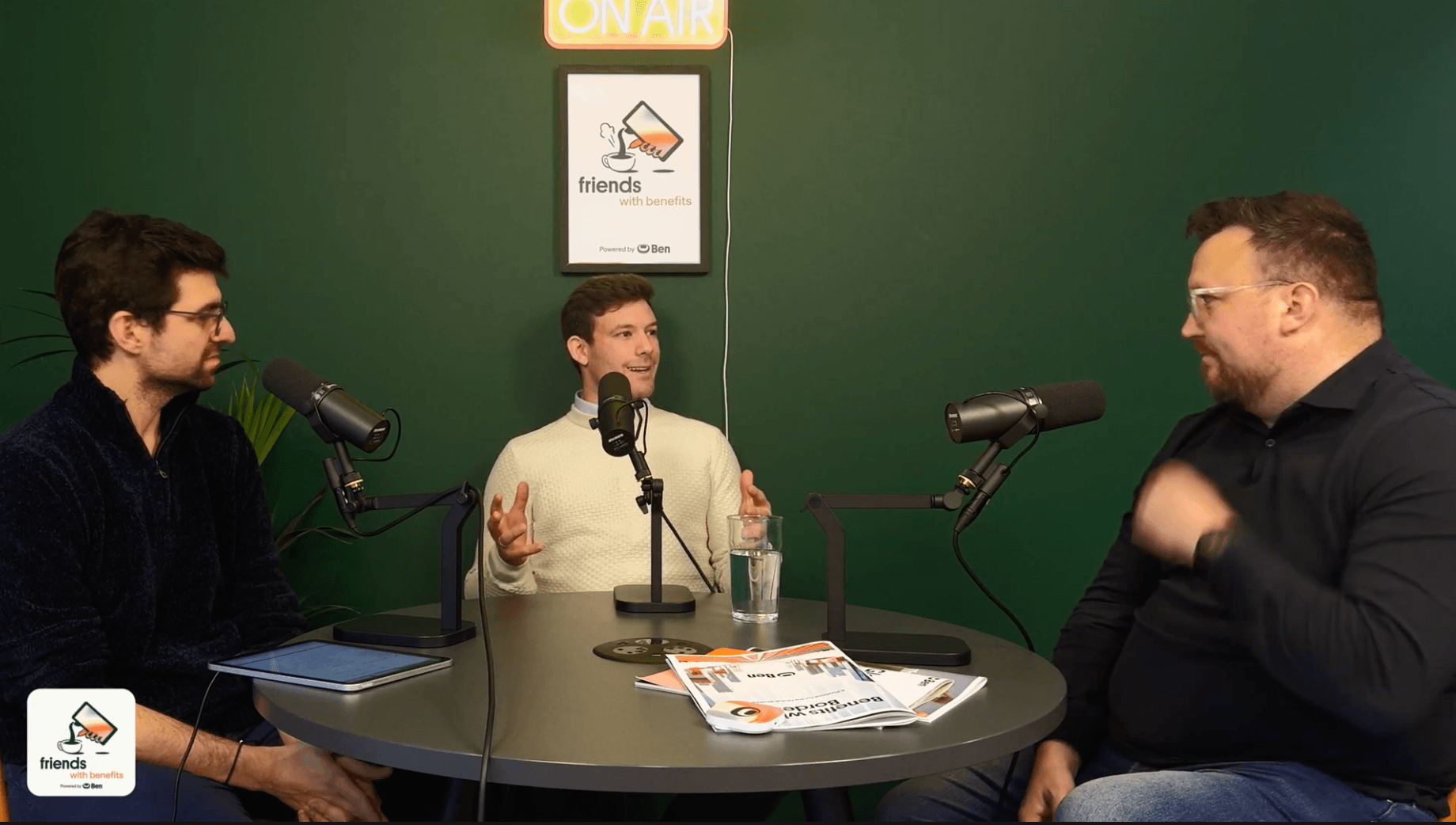 Dino Bertolis, Carl Chapman and David Duckworth in conversation on the Friends with Benefits podcast set, seated at a round t