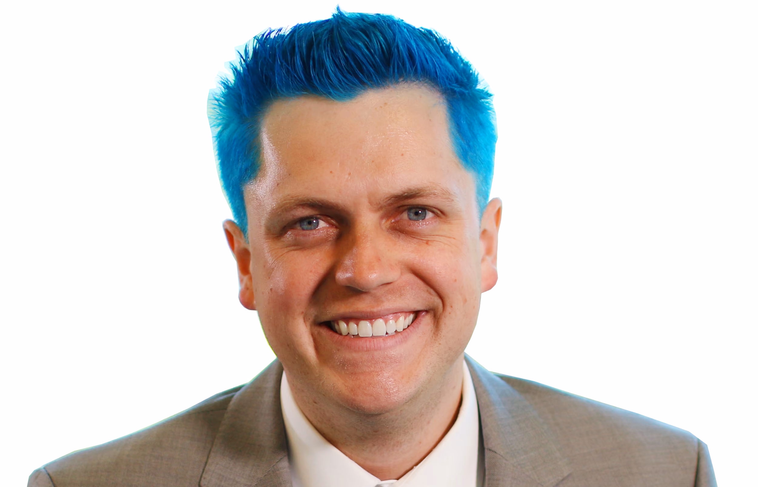 Smiling man with bright blue hair wearing a gray suit and white shirt against white background.