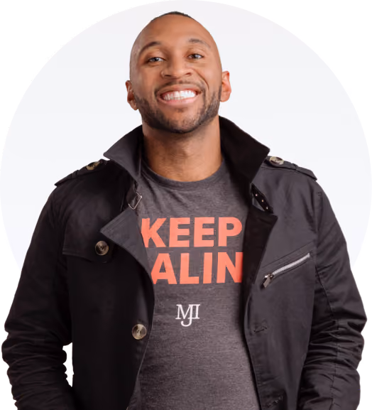 Smiling man wearing a black jacket and gray shirt with orange text reading Keep Calm and MJ logo.
