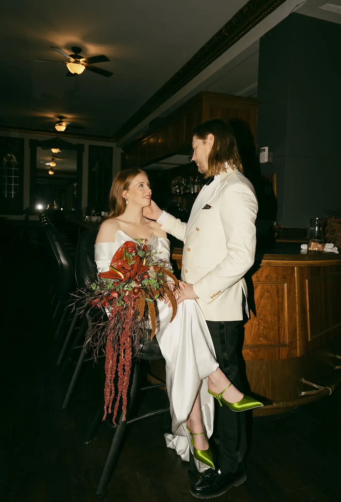 Modern intimate wedding portrait of a couple in a stylish indoor reception setting.