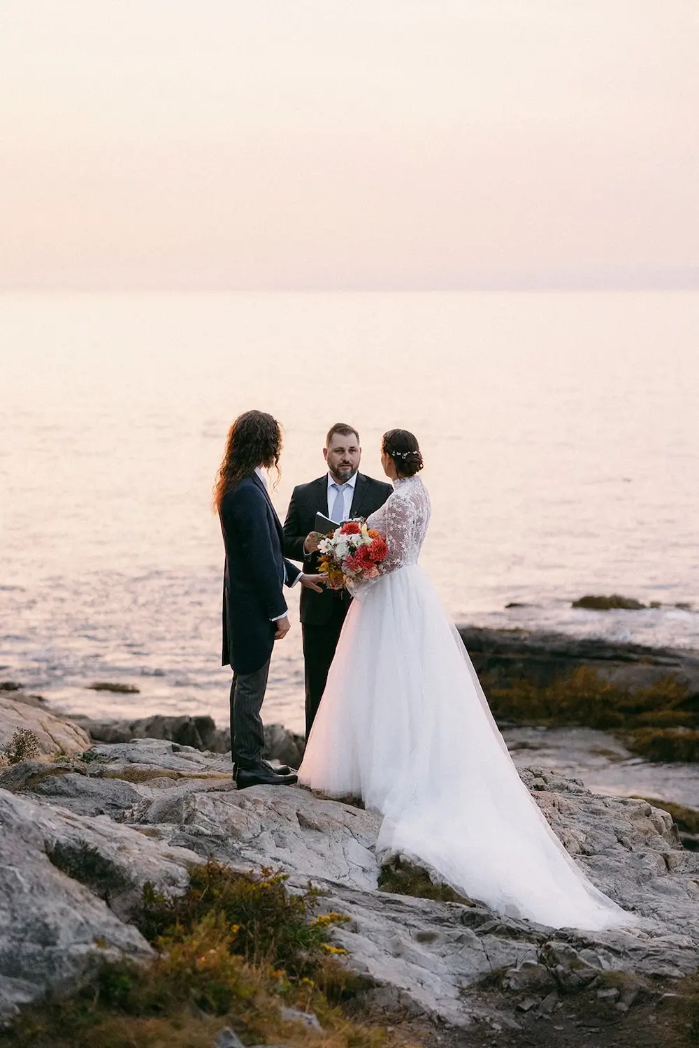 Small coastal wedding ceremony at Acadia National Park with ocean views