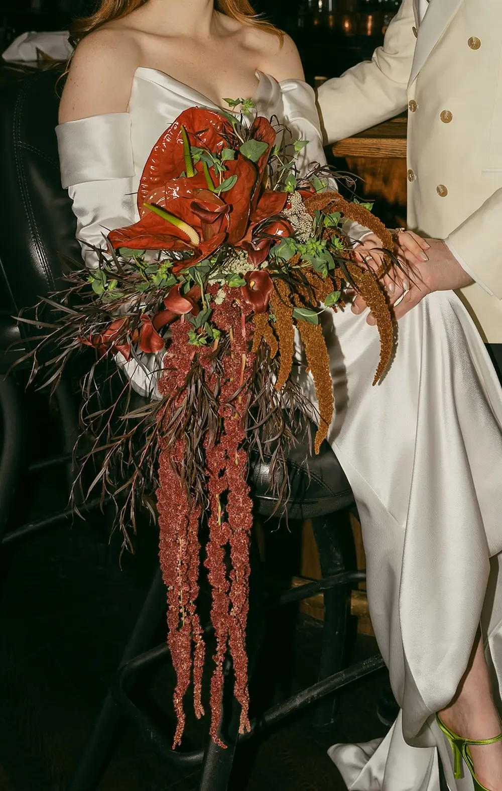 dramatic cascading wedding bouquet with red anthurium amaranthus and sculptural greenery