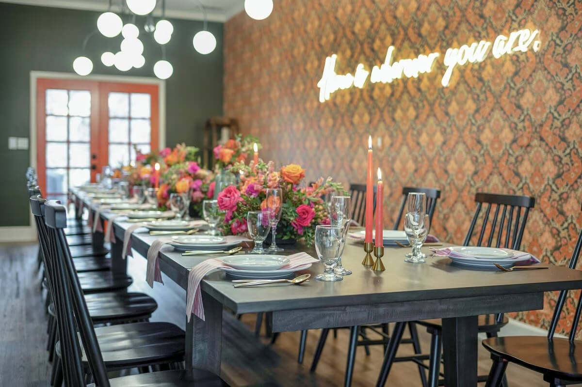 Luxury estate dining room with decorated table, flowers, and candlelight setup