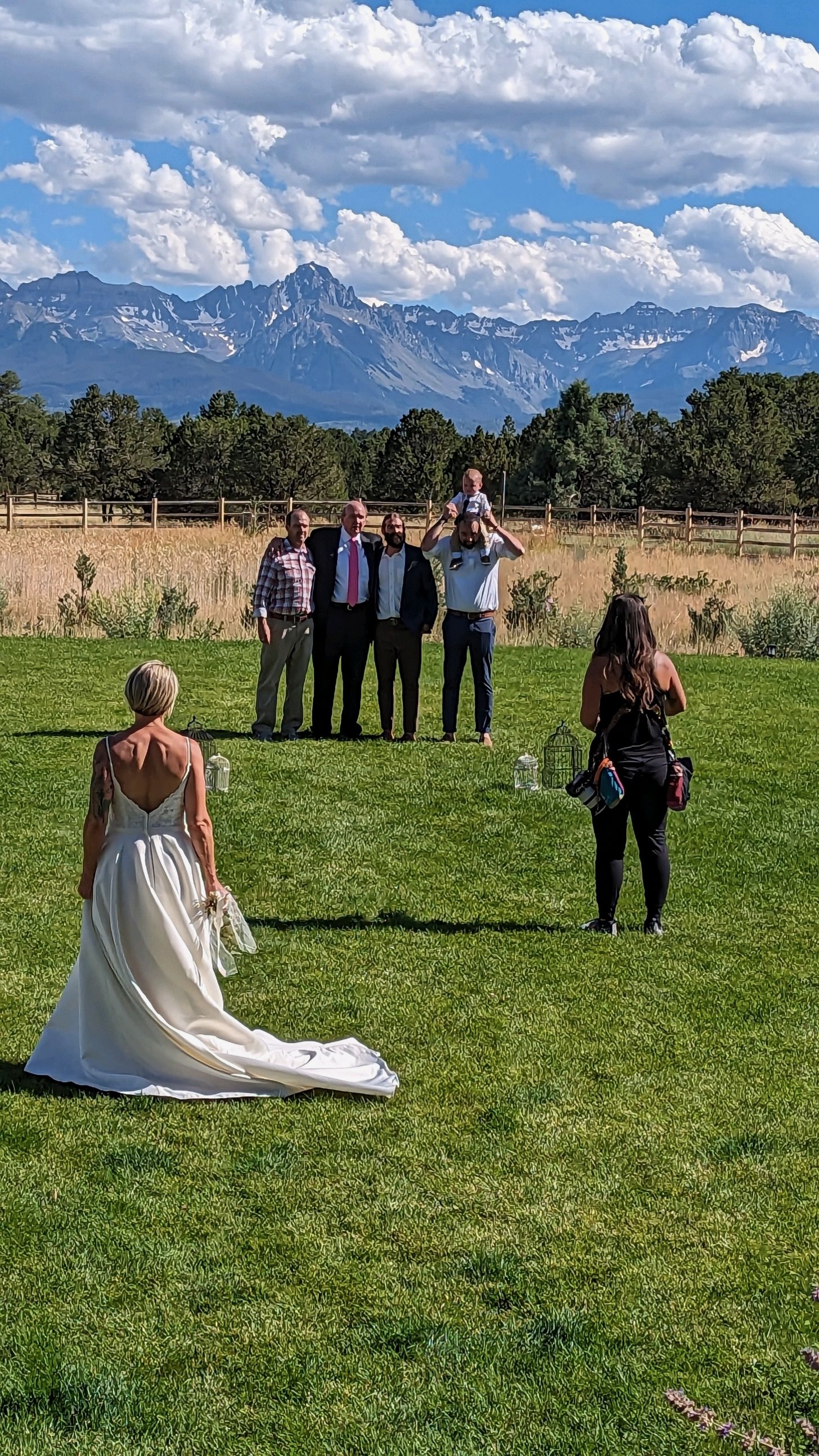 A wedding photographer captures family portraits during a small ceremony.