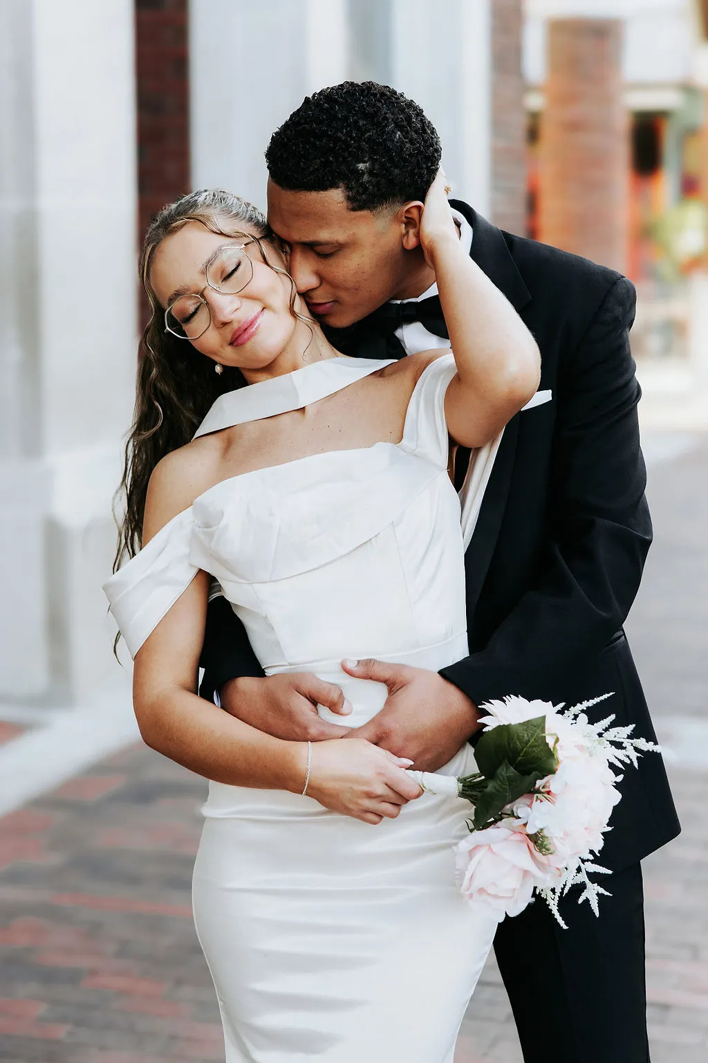 Couple poses outside a courthouse following their elopement.