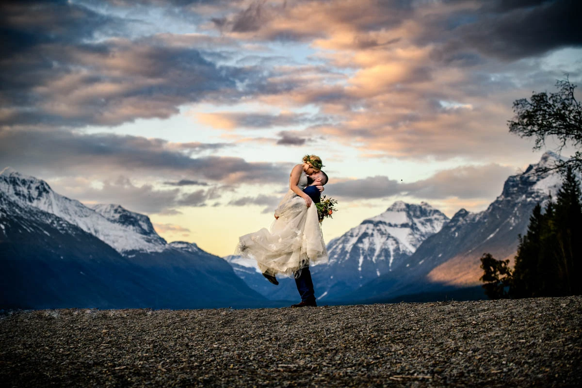A couple stands in a meadow at a national park destination elopement.