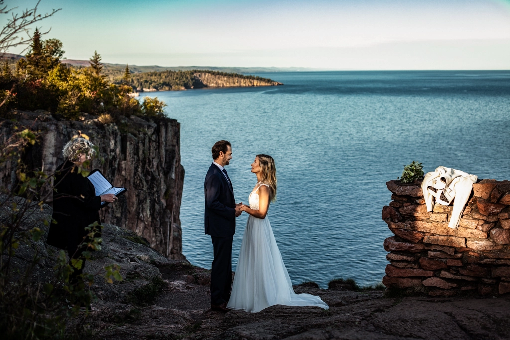 An officiant leads readings at an outdoor elopement ceremony.