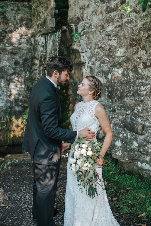 Couple stands in front of a waterfall at a micro wedding venue in Pennsylvania
