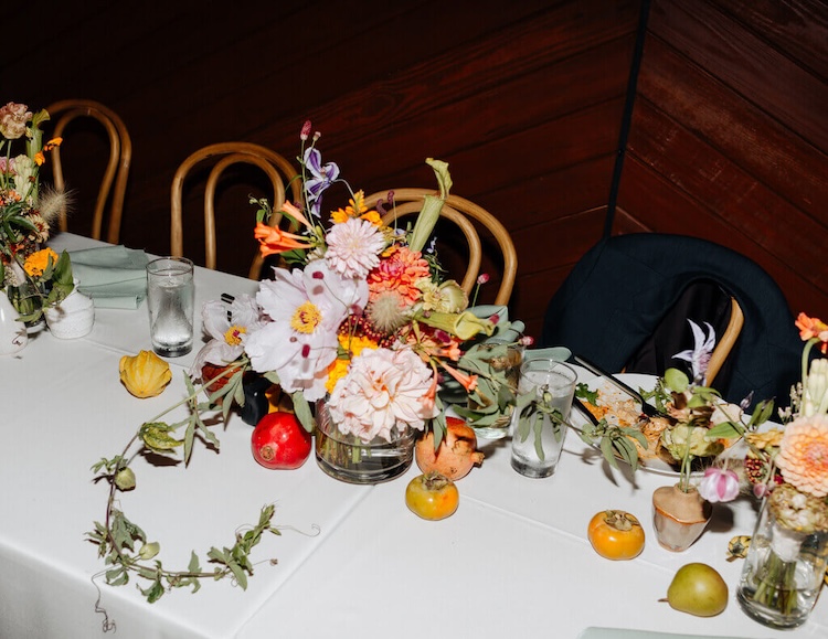 Whimsical floral and fruit wedding centerpiece