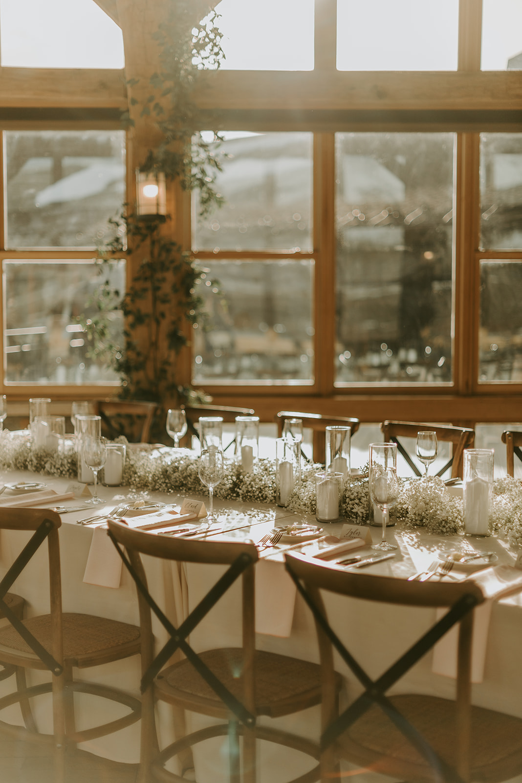A wedding table with a simple baby's breath centerpiece