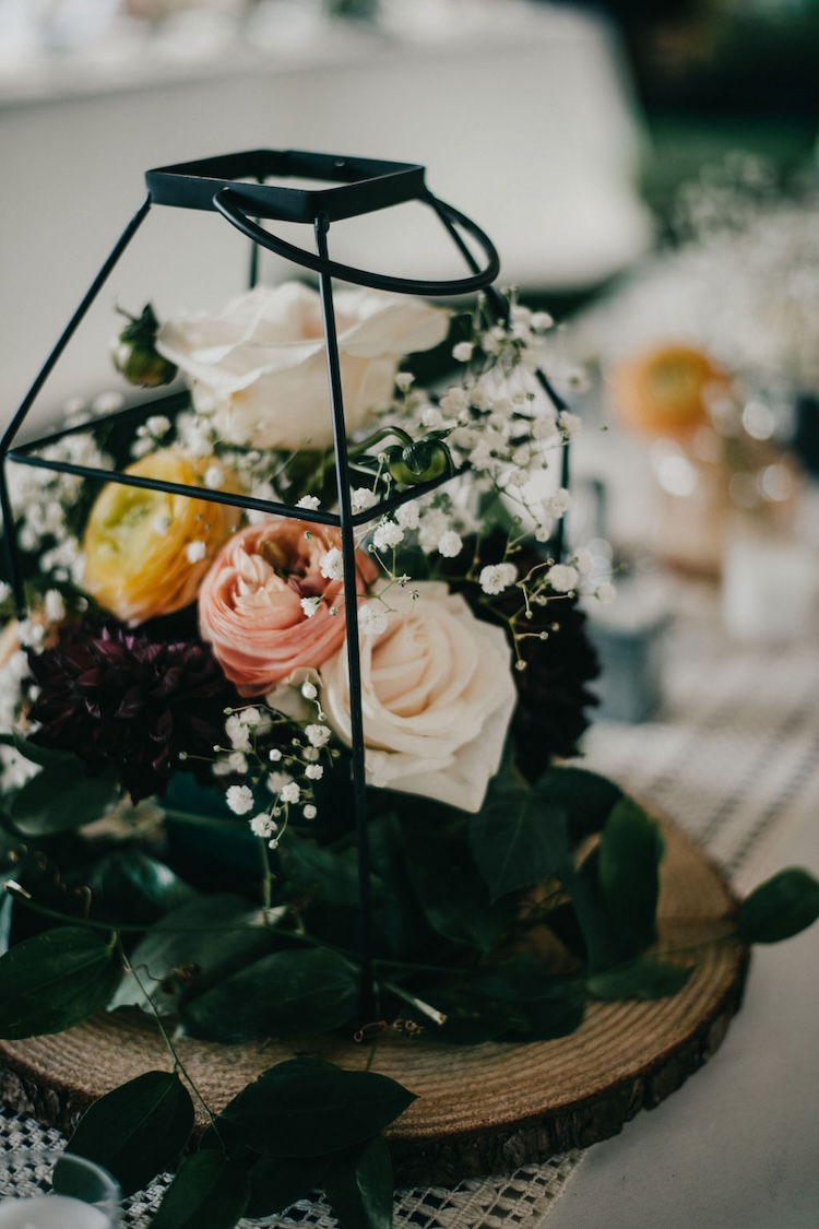 Geometric metallic vase wedding centerpiece with greenery and candles
