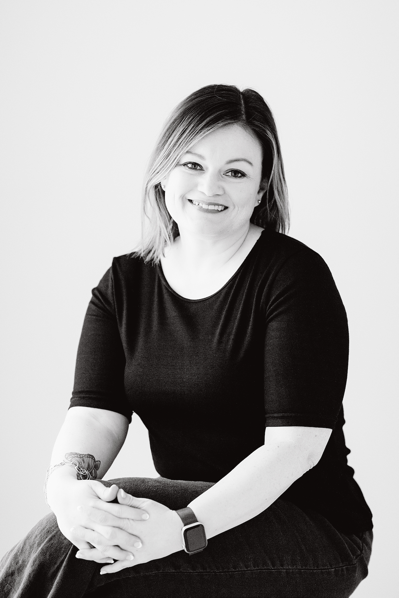 Sandra Halling, systems strategist and fractional CIO, smiling while seated.