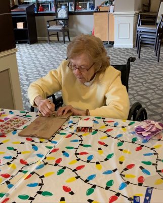 An OESH senior woman making arts and crafts for fun.