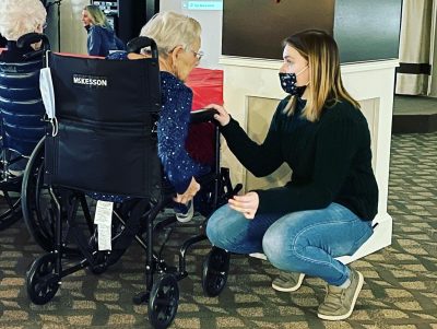 A care staff member speaking to an OESH senior.