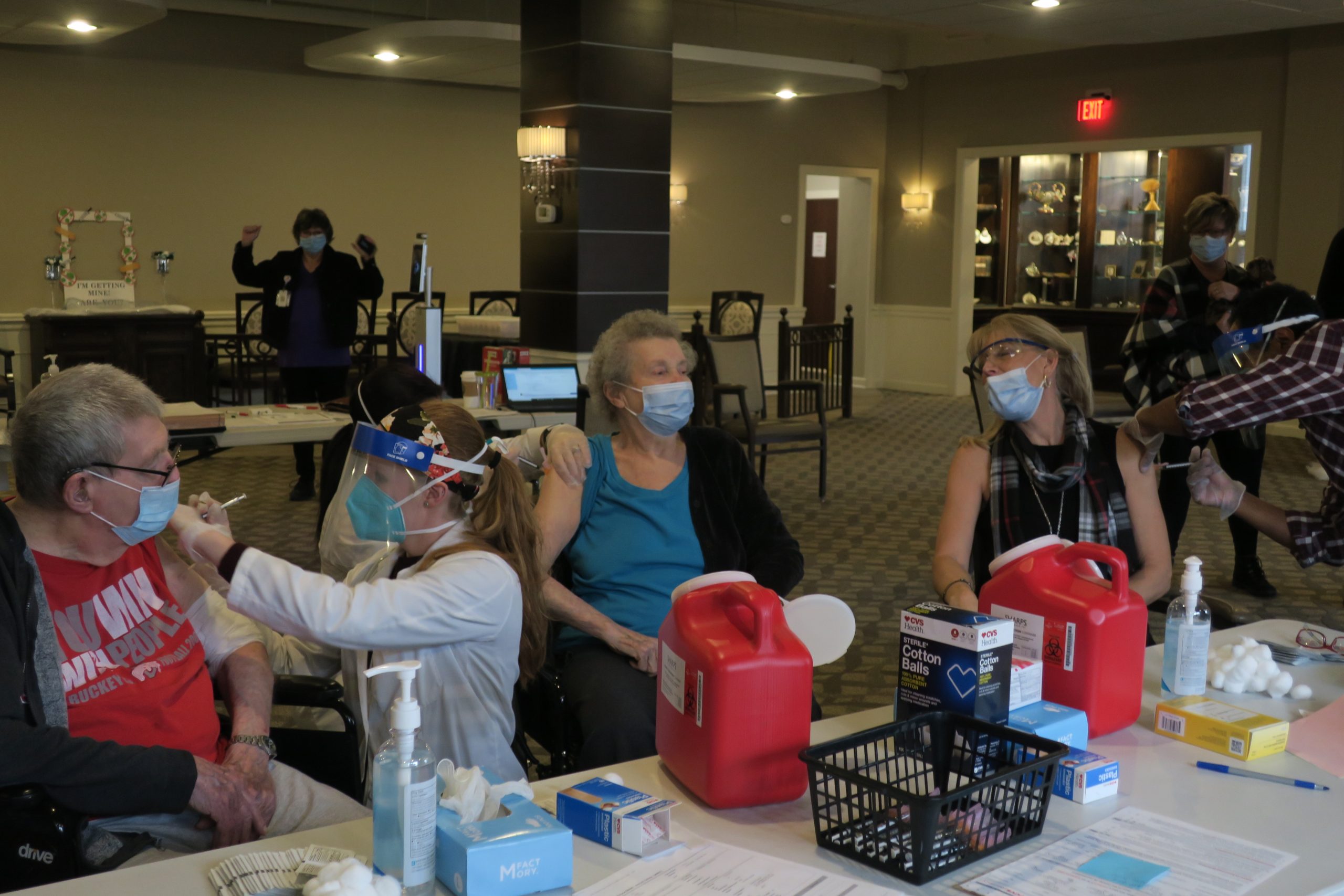 A medical professional gives out vaccinations at a medical station.