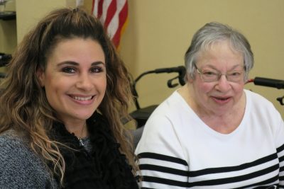 A young woman with a beautiful smile and a senior woman with wise eyes.