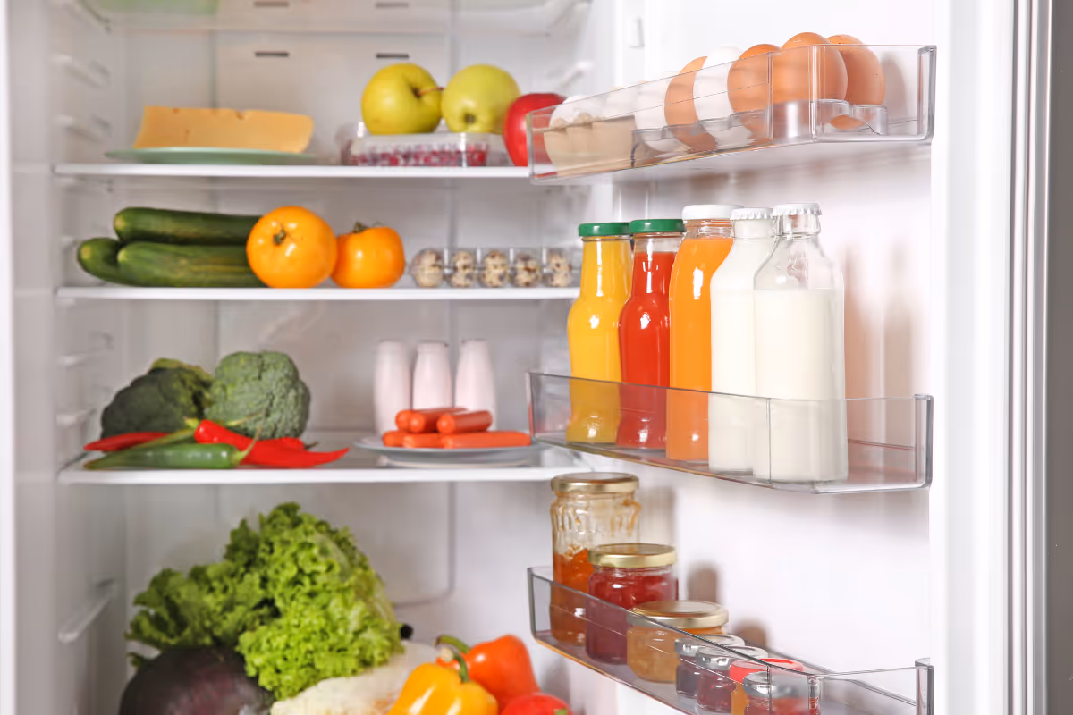 A clean, organized fridge full of fresh produce