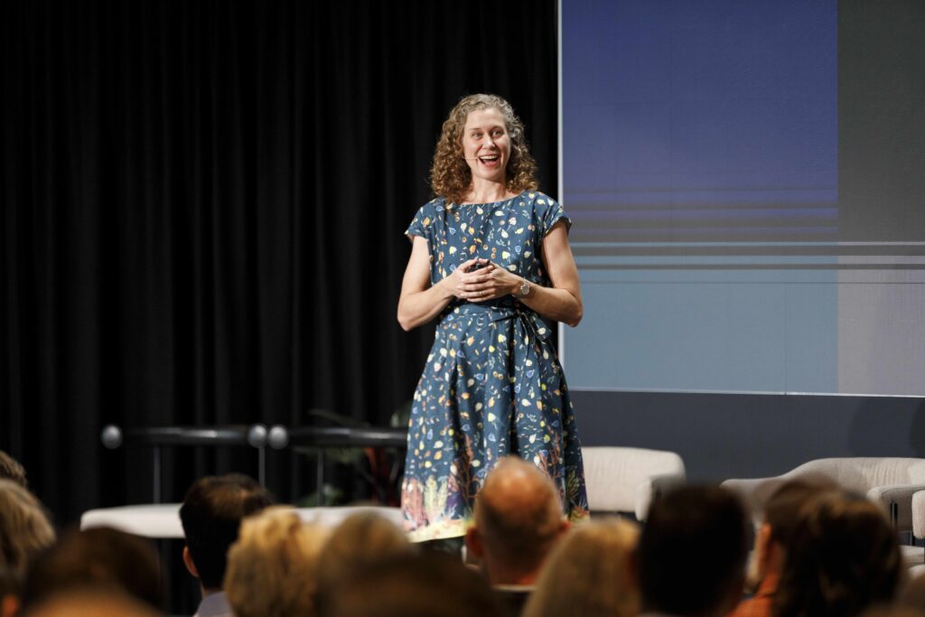 Photo of Dorothy Dankel on stage in front of the audience at a conference