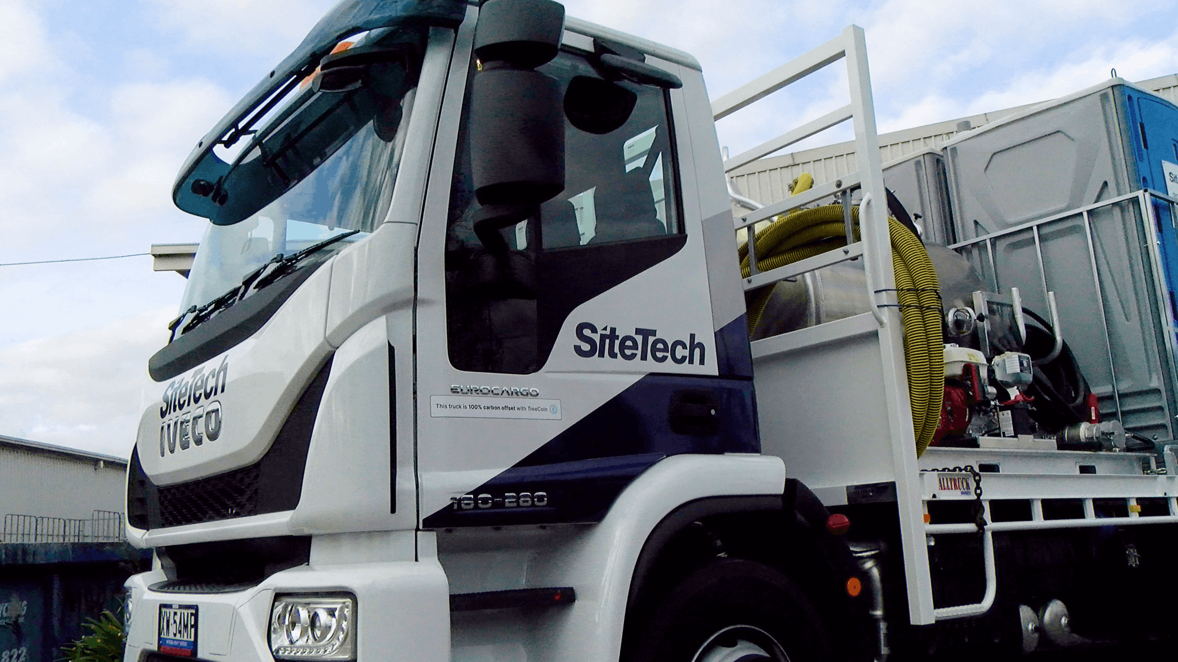 A construction equipment truck with carbon drawdown sticker on it